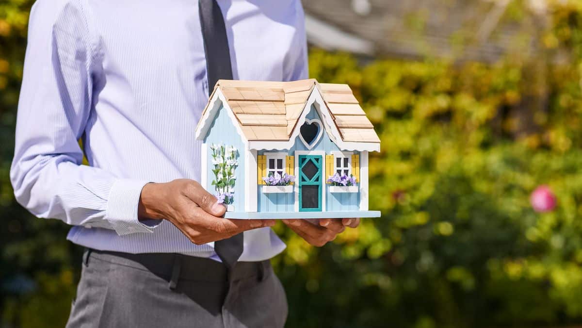 Couple reviewing paperwork while buying a house, representing the choice between a 15-year and 30-year mortgage